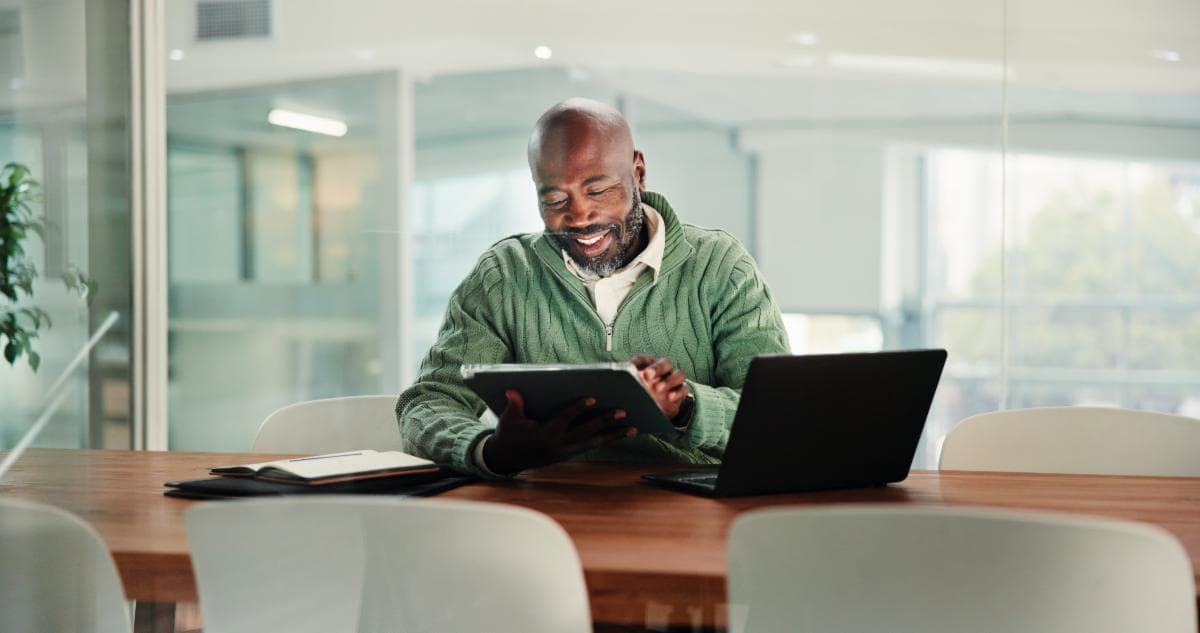 Insurance agent reviewing policy details on a tablet in office